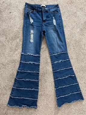 Distressed Dark Blue Flared Jeans with Tiered Ruffle Detail
